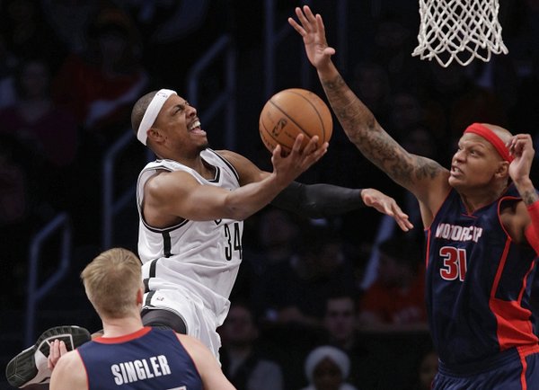 Detroit Pistons forward Charlie Villanueva (31) defends as Brooklyn Nets forward Paul Pierce (34) goes up for a layup in the second half of an NBA basketball game, Sunday, Nov. 24, 2013, in New York. The Pistons won 109-97. (AP Photo/Kathy Willens) 