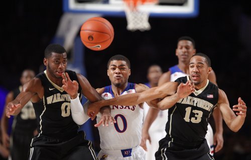 Kansas guard Frank Mason fights for a loose ball with Wake Forest defenders Codi Miller-McIntyre (0) and Coron Williams during the first half of the Battle 4 Atlantis opening round on Thursday, Nov. 28, 2013 in Paradise Island, Bahamas.