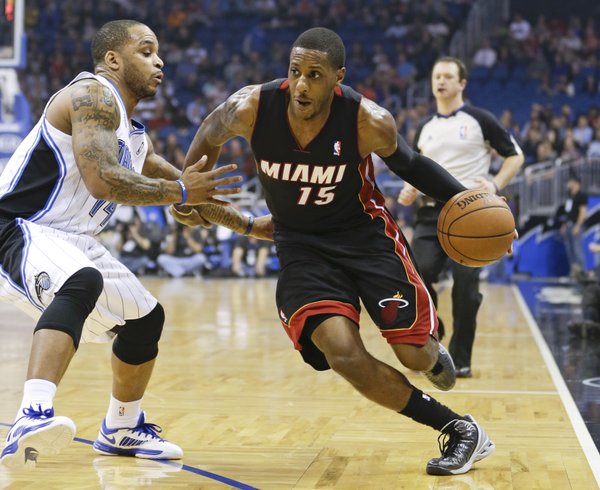 Miami Heat's Mario Chalmers (15) drives around Orlando Magic's Jameer Nelson, left, during the first half of an NBA basketball game in Orlando, Fla., Wednesday, Nov. 20, 2013.(AP Photo/John Raoux)
