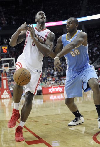 Denver Nuggets' Darrell Arthur (00) knocks the ball away from Houston Rockets' Terrence Jones in the second half of an NBA basketball game Saturday, Nov. 16, 2013, in Houston. The Rockets won 122-111. (AP Photo/Pat Sullivan)
