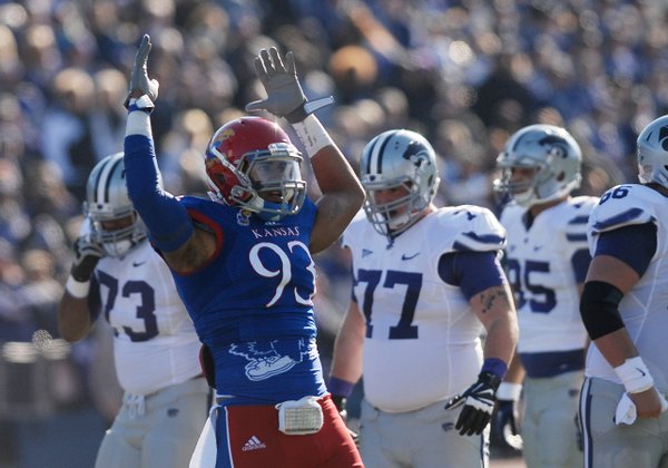 Kansas defender Ben Goodman (93) pumps his arms in the air to get the crowd into the game during the first-half of the Jayhawks game against KSU Saturday at Memorial Stadium.