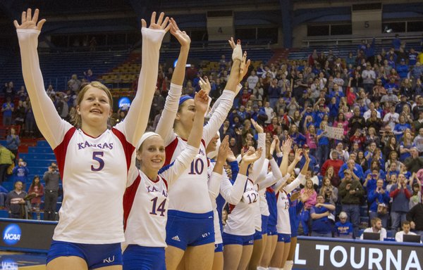 Kansas' Cassie Wait (5), Jamie Mathieu (14) and the rest of the Jayhawks wave to fans following Kansas' second round NCAA volleyball tournament match against Creighton, Saturday at Allen Fieldhouse. The Jayhawks downed the Bluejays, 3-1, and with the win, avenged a loss to Creighton earlier in the year.