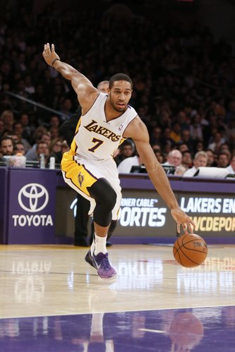 Los Angeles Lakers' Xavier Henry dribbles the ball during the NBA basketball game against the Toronto Raptors in Los Angeles, Sunday, Dec. 8, 2013. The Raptors won 106-94. (AP Photo/Danny Moloshok) 