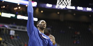 Kansas center Joel Embiid turns for a shot during warmups prior to tipoff against New Mexico on Saturday, Dec. 14, 2013 at Sprint Center in Kansas City, Mo.