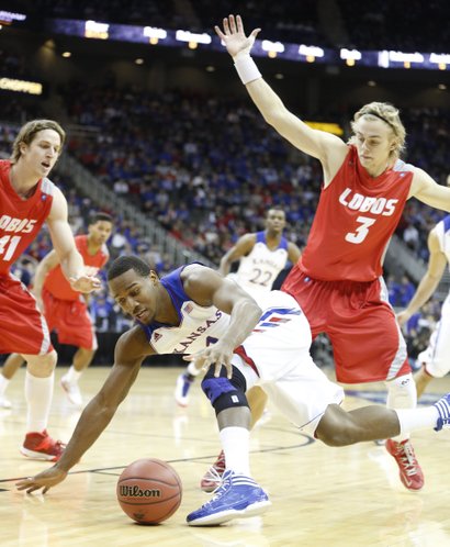Kansas guard Wayne Selden tries to maintain control of the ball as he is defended by New Mexico players Cameron Bairstow (41) and Hugh Greenwood (3) during the first half on Saturday, Dec. 14, 2013 at Sprint Center in Kansas City, Mo.