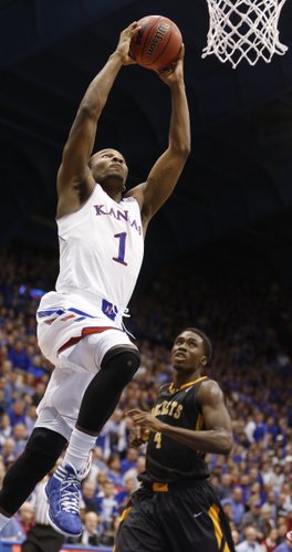 Kansas guard Wayne Selden elevates for a jam before Toledo guard Justin Drummond during the second half on Monday, Dec. 30, 2013 at Allen Fieldhouse.