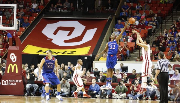 Kansas guard Andrew Wiggins blocks a late three from Oklahoma guard Frank Booker during the second half on Wednesday, Jan. 8, 2013 at Lloyd Noble Center in Norman, Oklahoma.