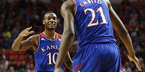 Kansas guard Naadir Tharpe looks to slap hands with center Joel Embiid after an Oklahoma foul during the first half on Wednesday, Jan. 8, 2013 at Lloyd Noble Center in Norman, Oklahoma.