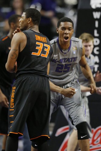 Kansas State forward Wesley Iwundu (25) and Oklahoma State guard Marcus Smart (33) at the end of an NCAA college basketball game at Bramlage Coliseum in Manhattan, Kan., Saturday, Jan. 4, 2014. Kansas State defeated Oklahoma State 71-74. (AP Photo/Orlin Wagner)
