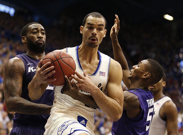 Kansas forward Perry Ellis comes down with a rebound between Kansas State players Thomas Gipson, left, and Jevon Thomas during the second half on Saturday, Jan. 11, 2014 at Allen Fieldhouse.