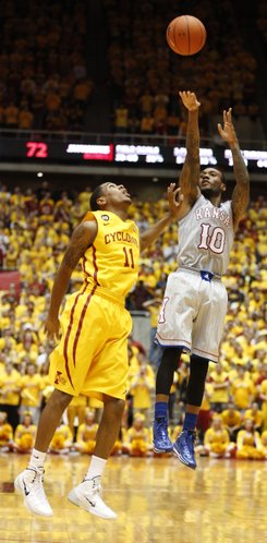 Kansas guard Naadir Tharpe puts up a shot over Iowa State guard Monte Morris during the second half on Monday, Jan. 13, 2014 at Hilton Coliseum in Ames, Iowa.