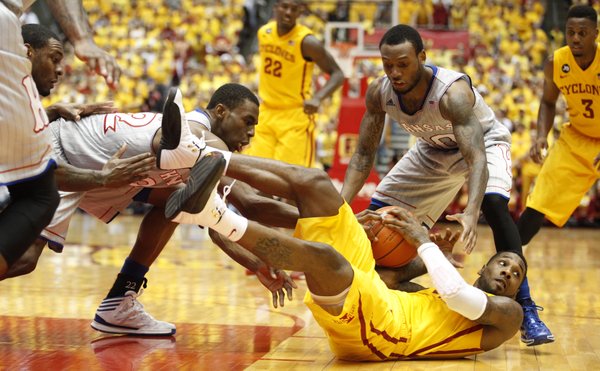 Kansas guards Andrew Wiggins, left, and Naadir Tharpe look to tie up Iowa State guard DeAndre Kane during the first half on Monday, Jan. 13, 2014 at Hilton Coliseum in Ames, Iowa.