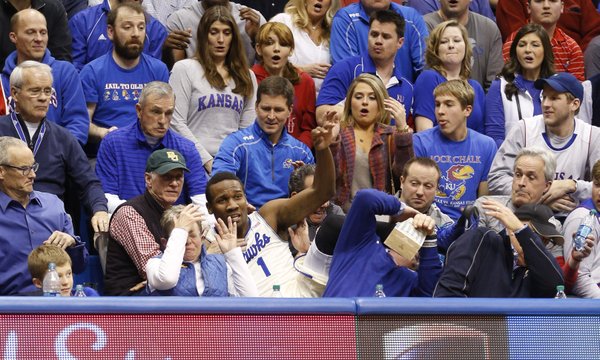 Fans react as Kansas guard Wayne Selden crashes into the seats after saving a ball that was tossed to teammate Joel Embiid for a bucket during the second half on Monday, Jan. 20, 2014 at Allen Fieldhouse.