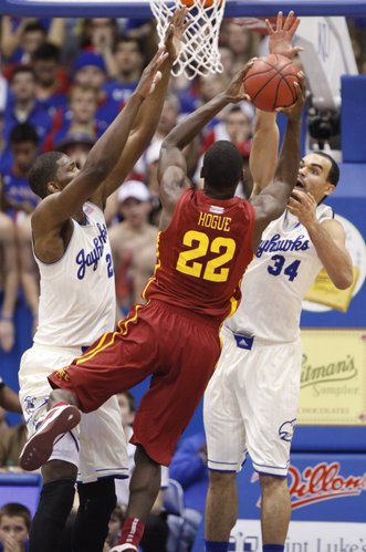 Kansas players Joel Embiid, left, and Perry Ellis defend against a shot from Iowa State forward Dustin Hogue during the first half on Wednesday, Jan. 29, 2014 at Allen Fieldhouse.
