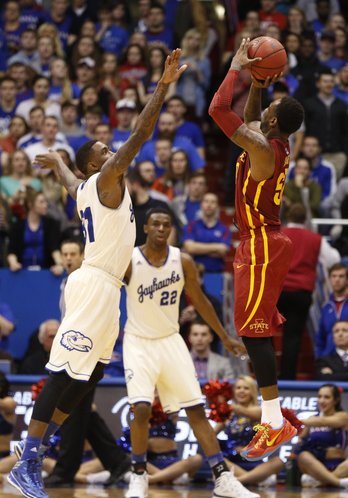Kansas forward Jamari Traylor gets a hand in the face of Iowa State guard DeAndre Kane as he puts up a three late in the second half on Wednesday, Jan. 29, 2014 at Allen Fieldhouse.