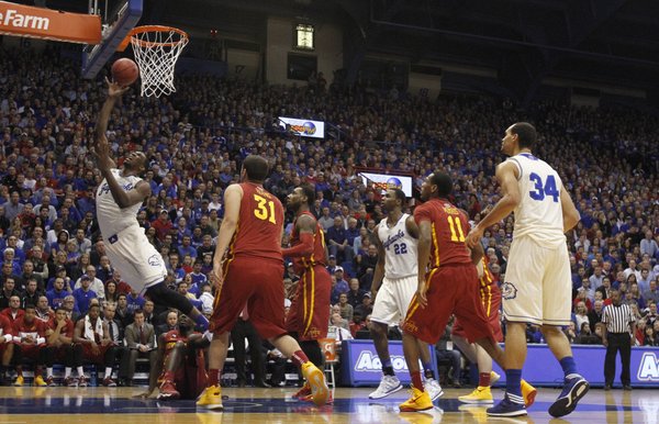 Kansas center Joel Embiid lunges for a bucket after an Iowa State foul during the first half on Wednesday, Jan. 29, 2014 at Allen Fieldhouse.