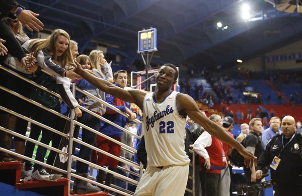 Kansas guard Andrew Wiggins slaps hands with the Jayhawk faithful as he leaves the court following a career high, 29 points against Iowa State in the Jayhawks' 92-81 win, Wednesday, Jan. 29, 2014 at Allen Fieldhouse.