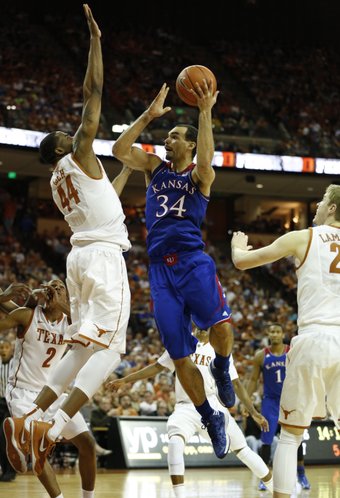 Kansas forward Perry Ellis turns for a shot against Texas center Prince Ibeh during the second half on Saturday, Feb. 1, 2014 at Erwin Center in Austin, Texas.
