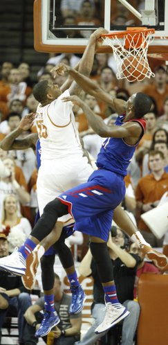 Texas center Cameron Ridley throws down a dunk before Kansas center Joel Embiid after being fouled during the second half on Saturday, Feb. 1, 2014 at Erwin Center in Austin, Texas.