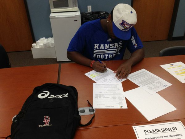 Damani Mosby of Mesa C.C., signing his letter of intent to join the Jayhawks. 