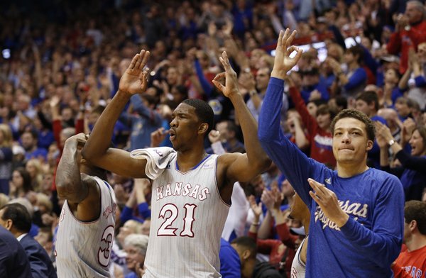 Kansas players Jamari Traylor, left, Joel Embiid, center, and Brannen Greene celebrate a three from teammate Wayne Selden against West Virginia during the second half on Saturday, Feb. 8, 2014 at Allen Fieldhouse.