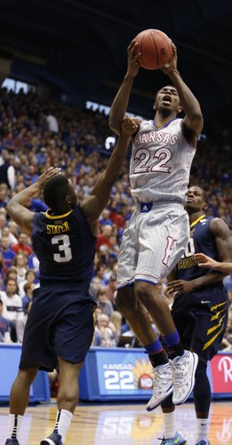 Kansas guard Andrew Wiggins hops into the lane for a shot against West Virginia guard Juwan Staten during the second half on Saturday, Feb. 8, 2014 at Allen Fieldhouse.
