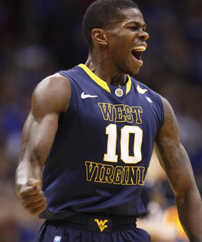 West Virginia guard Eron Harris pumps his fist after hitting a three against the Jayhawks during the first half on Saturday, Feb. 8, 2014 at Allen Fieldhouse.