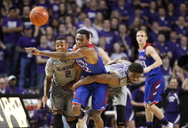 Kansas guard Andrew Wiggins tries to break through Kansas State players Marcus Foster, left, and Nino Williams for a loose ball during the first half on Monday, Feb. 10, 2014 at Bramlage Coliseum.