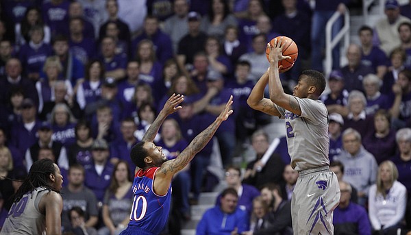Kansas State guard Marcus Foster pulls up for a three before Kansas guard Naadir Tharpe during the second half on Monday, Feb. 10, 2014 at Bramlage Coliseum.