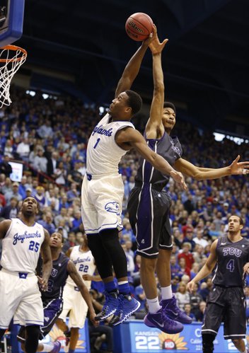 Kansas guard Wayne Selden is fouled by TCU center Karviar Shepherd as he pulls back for a dunk during the first half on Saturday, Feb. 15, 2014 at Allen Fieldhouse.