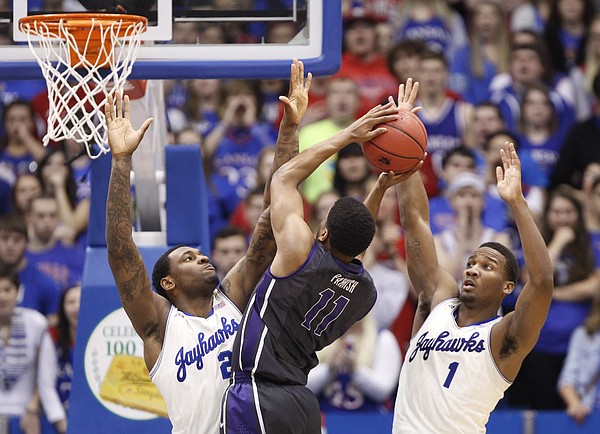 Kansas defenders Tarik Black, left, and Wayne Selden try to smother a shot by TCU forward Brandon Parrish during the second half on Saturday, Feb. 15, 2014 at Allen Fieldhouse.