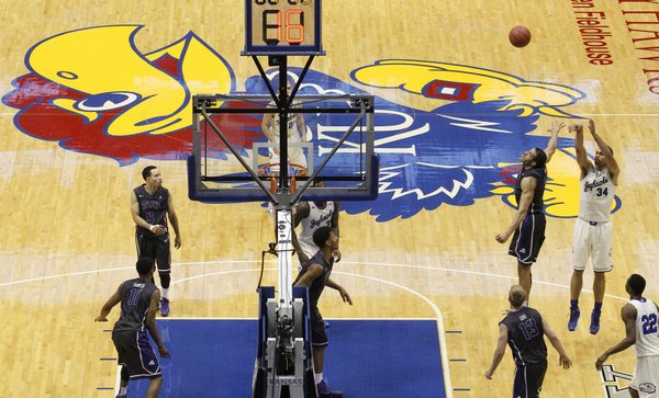 Kansas forward Perry Ellis puts up a shot over TCU forward Amric Fields during the second half on Saturday, Feb. 15, 2014 at Allen Fieldhouse.