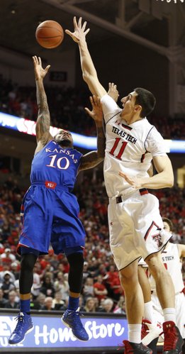 Texas Tech forward Dejan Kravic extends an arm in the face of a shot by Kansas guard Naadir Tharpe during the first half on Tuesday, Feb. 18, 2014 at United Spirit Arena in Lubbock, Texas.