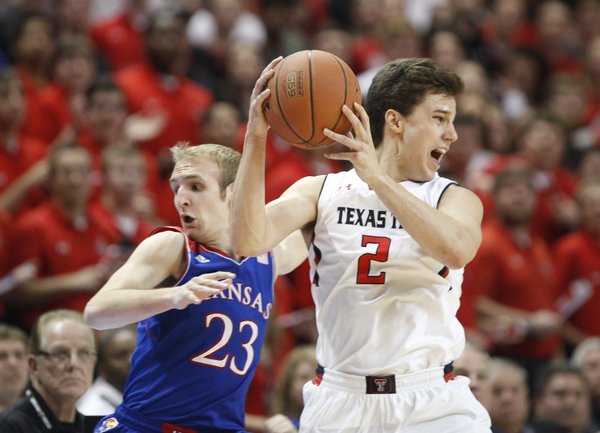Kansas guard Conner Frankamp heads out of bounds as Texas Tech guard Dusty Hannahs tries to save the ball during the first half on Tuesday, Feb. 18, 2014 at United Spirit Arena in Lubbock, Texas.