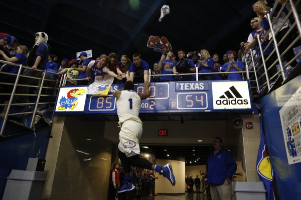 Kansas guard Wayne Selden jumps to slap hands with a row of Jayhawk fans after defeating Texas 85-54 on Saturday, Feb. 22, 2014 at Allen Fieldhouse.