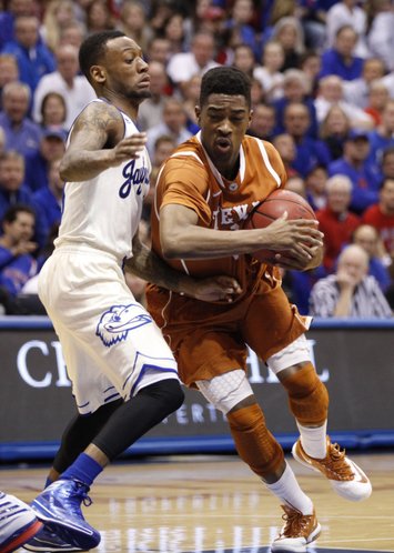 Kansas guard Naadir Tharpe defends against a drive by Texas guard Isaiah Taylor during the second half on Saturday, Feb. 22, 2014 at Allen Fieldhouse.