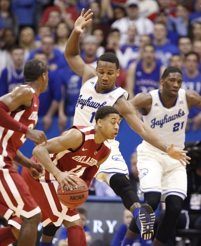 Kansas guard Wayne Selden defends a drive by Oklahoma guard Isaiah Cousins during the first half on Monday, Feb. 24, 2014 at Allen Fieldhouse.