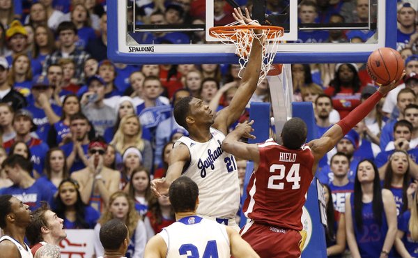 Kansas center Joel Embiid gets his hand caught in the net as he tries to block a shot by Oklahoma guard Buddy Hield during the second half on Monday, Feb. 24, 2014 at Allen Fieldhouse.