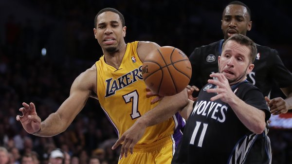 Los Angeles Lakers forward Xavier Henry, left, battles Minnesota Timberwolves guard J.J. Barea for a loose ball during the second half of an NBA basketball game in Los Angeles, Friday, Dec. 20, 2013. (AP Photo/Chris Carlson)