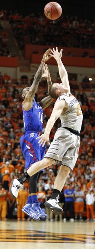 Kansas guard Naadir Tharpe hoists a three over Oklahoma State guard Phil Forte during the first half on Saturday, March 1, 2014 at Gallagher-Iba Arena in Stillwater, Oklahoma.
