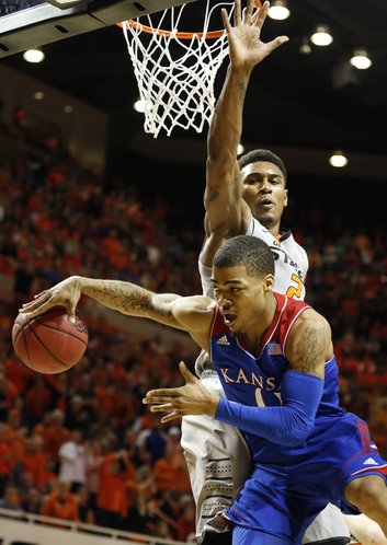 Kansas guard Frank Mason tries to hook a pass around Oklahoma State forward Le'Bryan Nash during the second half on Saturday, March 1, 2014 at Gallagher-Iba Arena in Stillwater, Oklahoma.