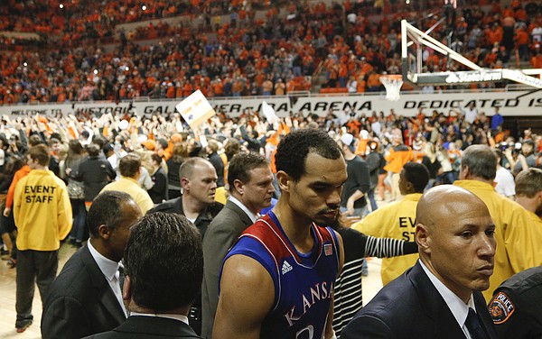 Kansas forward Perry Ellis makes his way to the locker room as Oklahoma State students storm the court following the Cowboys' 72-65 win on Saturday, March 1, 2014 at Gallagher-Iba Arena in Stillwater, Oklahoma.