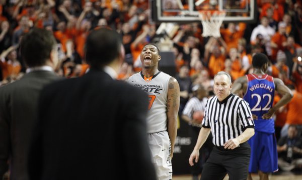 Oklahoma State guard Marcus Smart celebrates before the Kansas bench as the Cowboys close out the game on Saturday, March 1, 2014 at Gallagher-Iba Arena in Stillwater, Oklahoma.