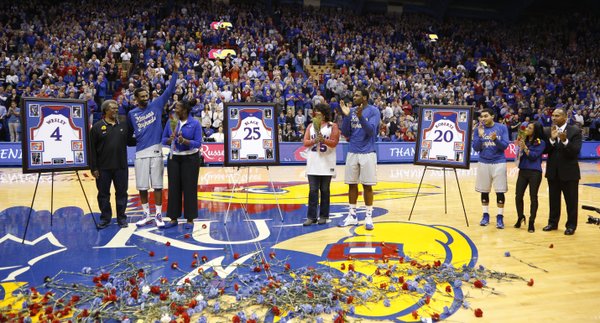 Kansas seniors Justin Wesley, left, Tarik Black and Niko Roberts are applauded by the fieldhouse during a ceremony honoring them with their families prior to tipoff against Texas Tech on Wednesday, March 5, 2014 at Allen Fieldhouse.