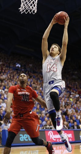 Kansas guard Brannen Greene comes in for a jam past Texas Tech forward Jaye Crockett during the second half on Wednesday, March 5, 2014 at Allen Fieldhouse.