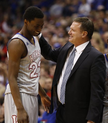 Kansas head coach Bill Self smiles and gives a pat to Andrew Wiggins after pulling him from the game late in the second half on Wednesday, March 5, 2014 at Allen Fieldhouse.