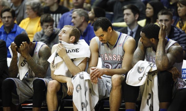 Kansas players Naadir Tharpe, left, Conner Frankamp, Perry Ellis and Tarik Black react to a foul called against the Jayhawks in the second half on Saturday, March 8, 2014 at WVU Coliseum in Morgantown, West Virginia.