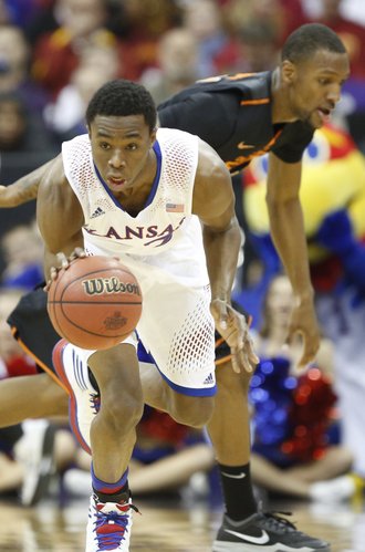 Kansas guard Andrew Wiggins takes off with a steal from Oklahoma State forward Kamari Murphy during the first half on Thursday, March 13, 2014 at Sprint Center in Kansas City, Missouri.