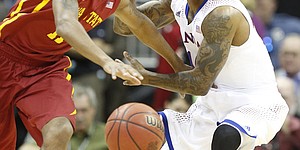 Kansas guard Naadir Tharpe looks to strip the ball from Iowa State guard Monte Morris during the first half on Friday, March 14, 2014 at Sprint Center in Kansas City, Missouri.
