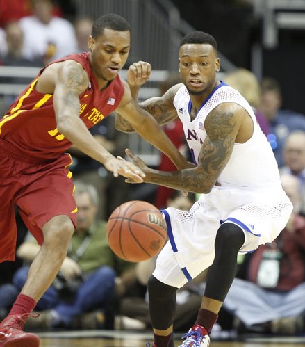 Kansas guard Naadir Tharpe looks to strip the ball from Iowa State guard Monte Morris during the first half on Friday, March 14, 2014 at Sprint Center in Kansas City, Missouri.